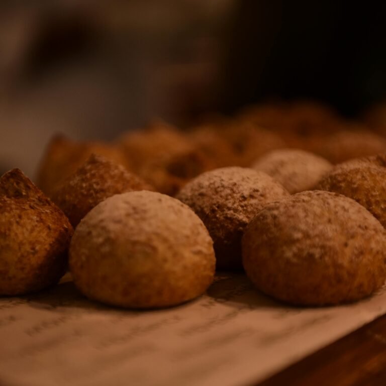 Warm image of freshly baked bread rolls on a wooden surface, showcasing texture.