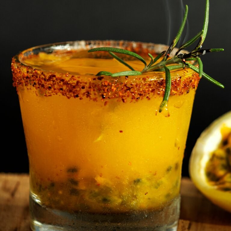 Vibrant mezcal cocktail enhanced with passion fruit and herbs in Guanajuato, Mexico.